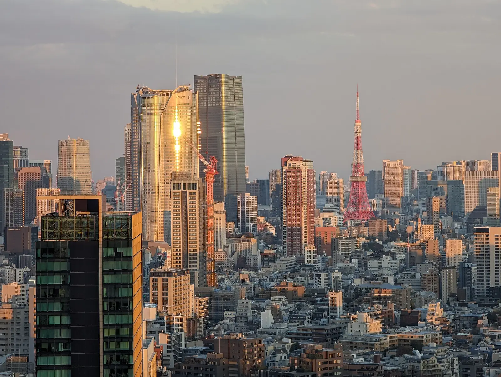 Roppongi Hills and Azabudai Hills towers with Tokyo Tower at sunset seen from Shibuya