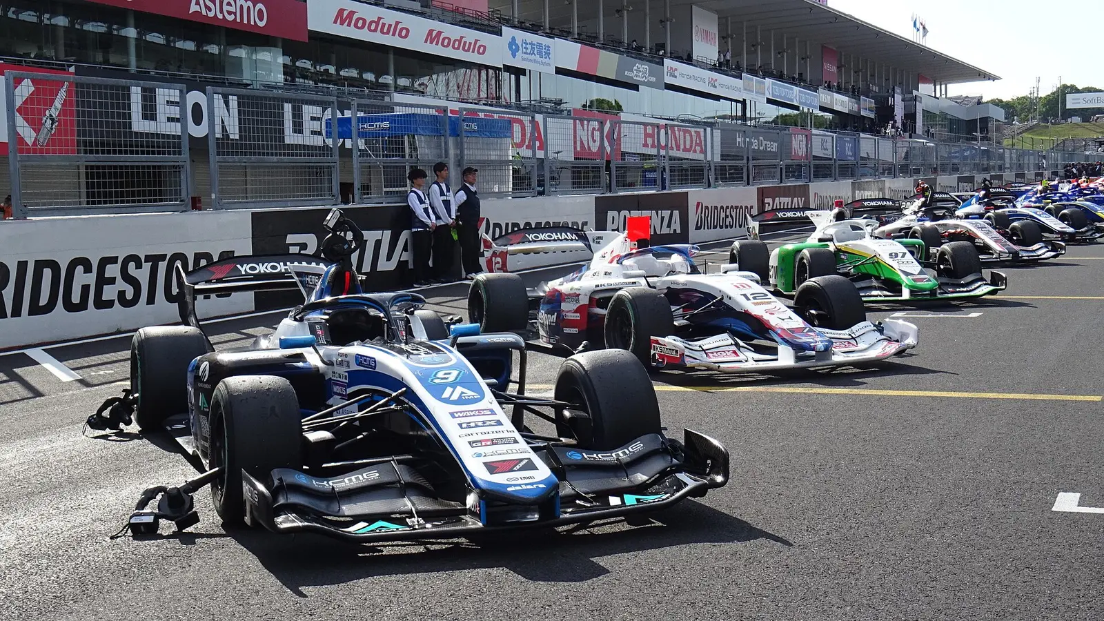 Super Formula cars lined up on the pit straight at Suzuka Circuit after the 2026 round