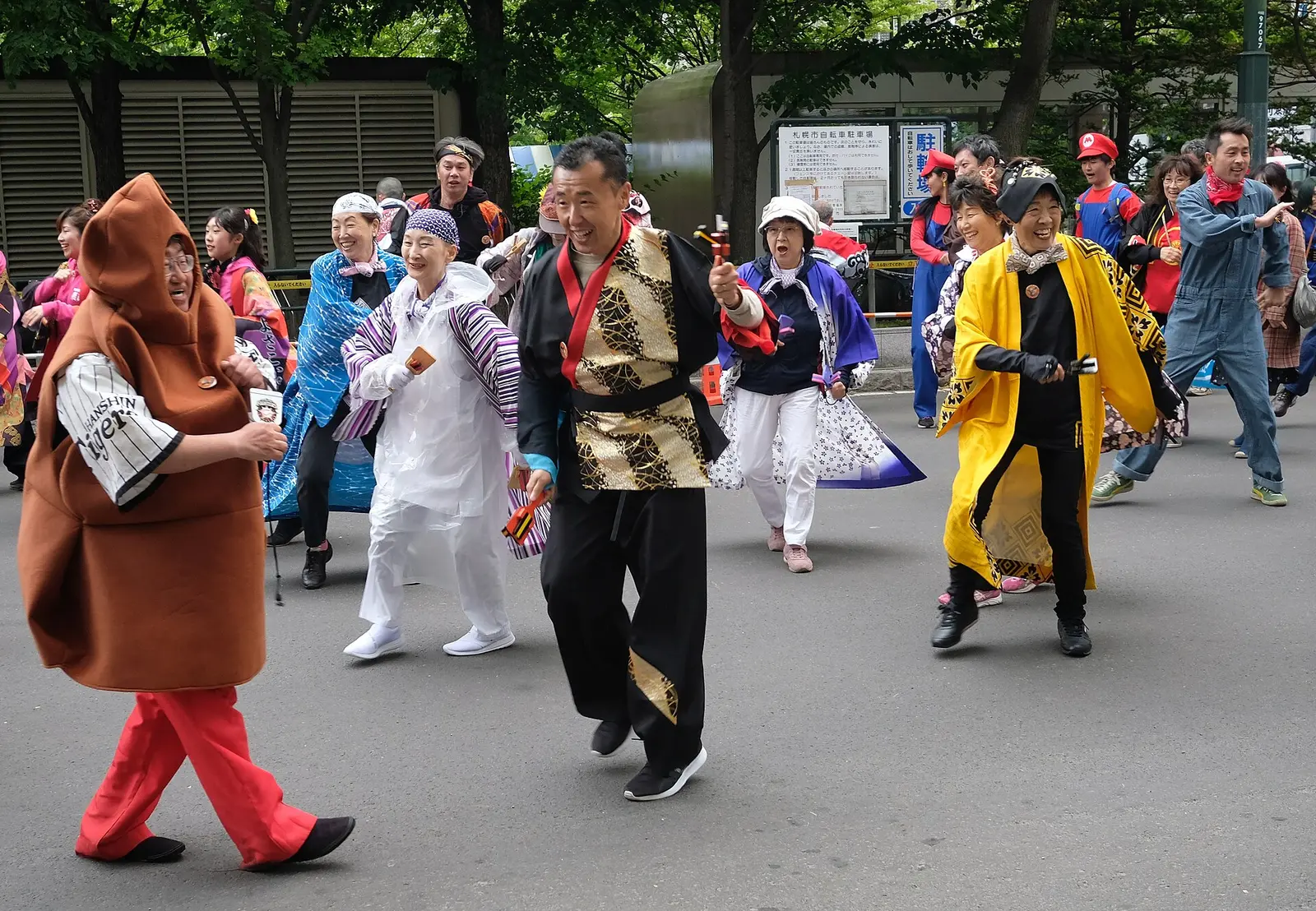 Dancers in costume parading on the street in Odori Park during the Yosakoi Soran festival